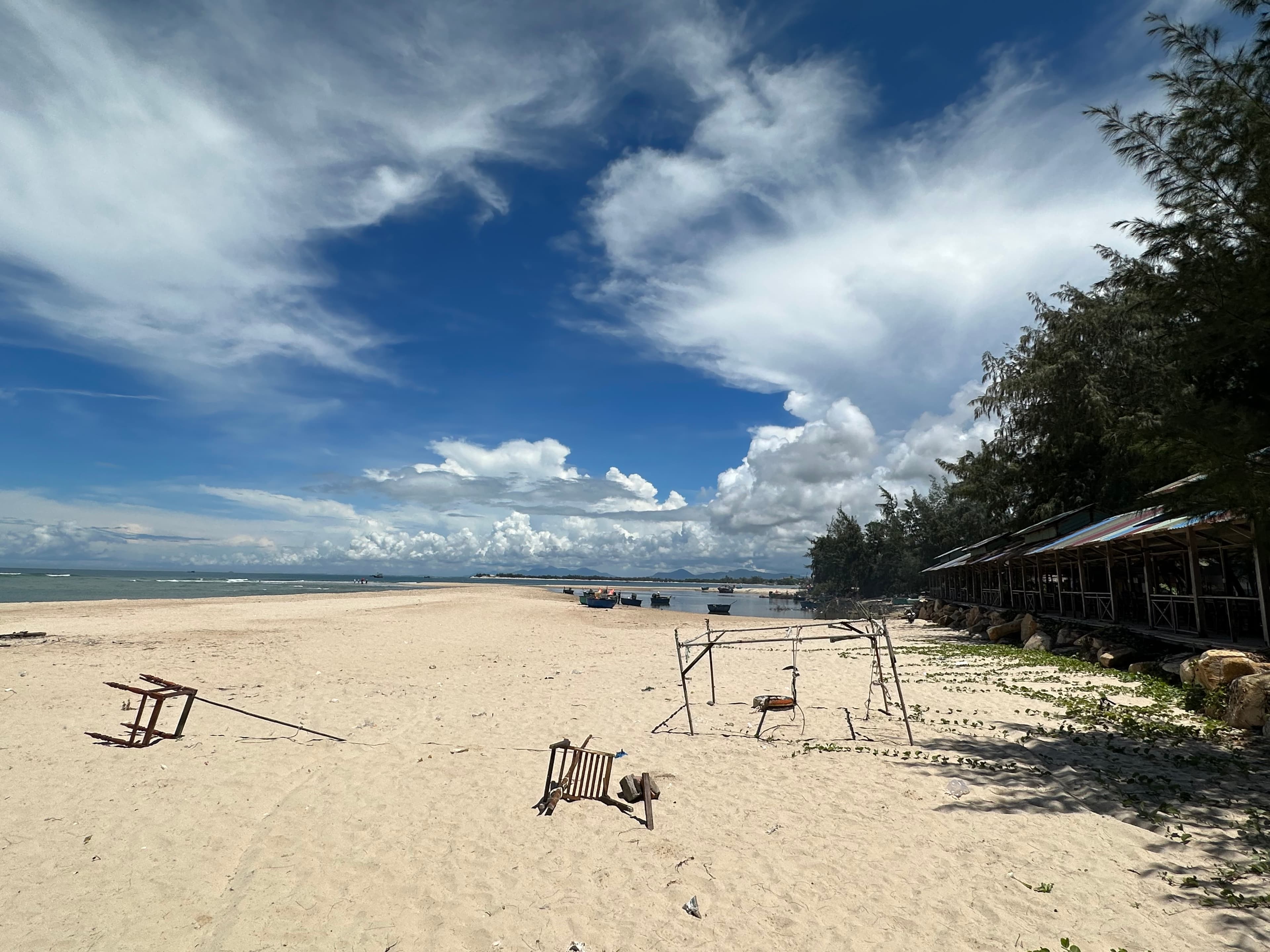 Weathered beach furniture standing beneath an open sky