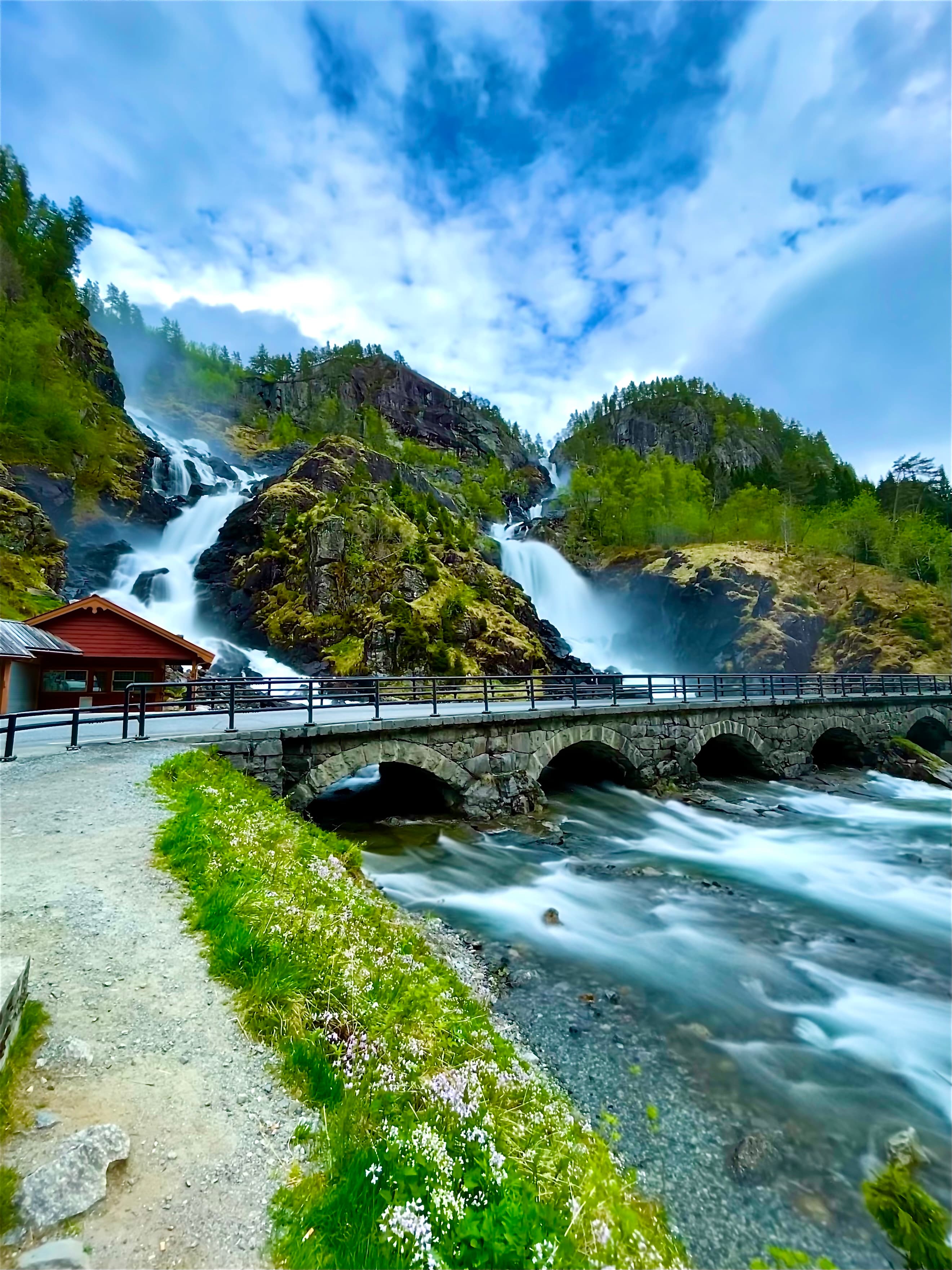Låtefossen cascading beside the historic stone bridge in Norway