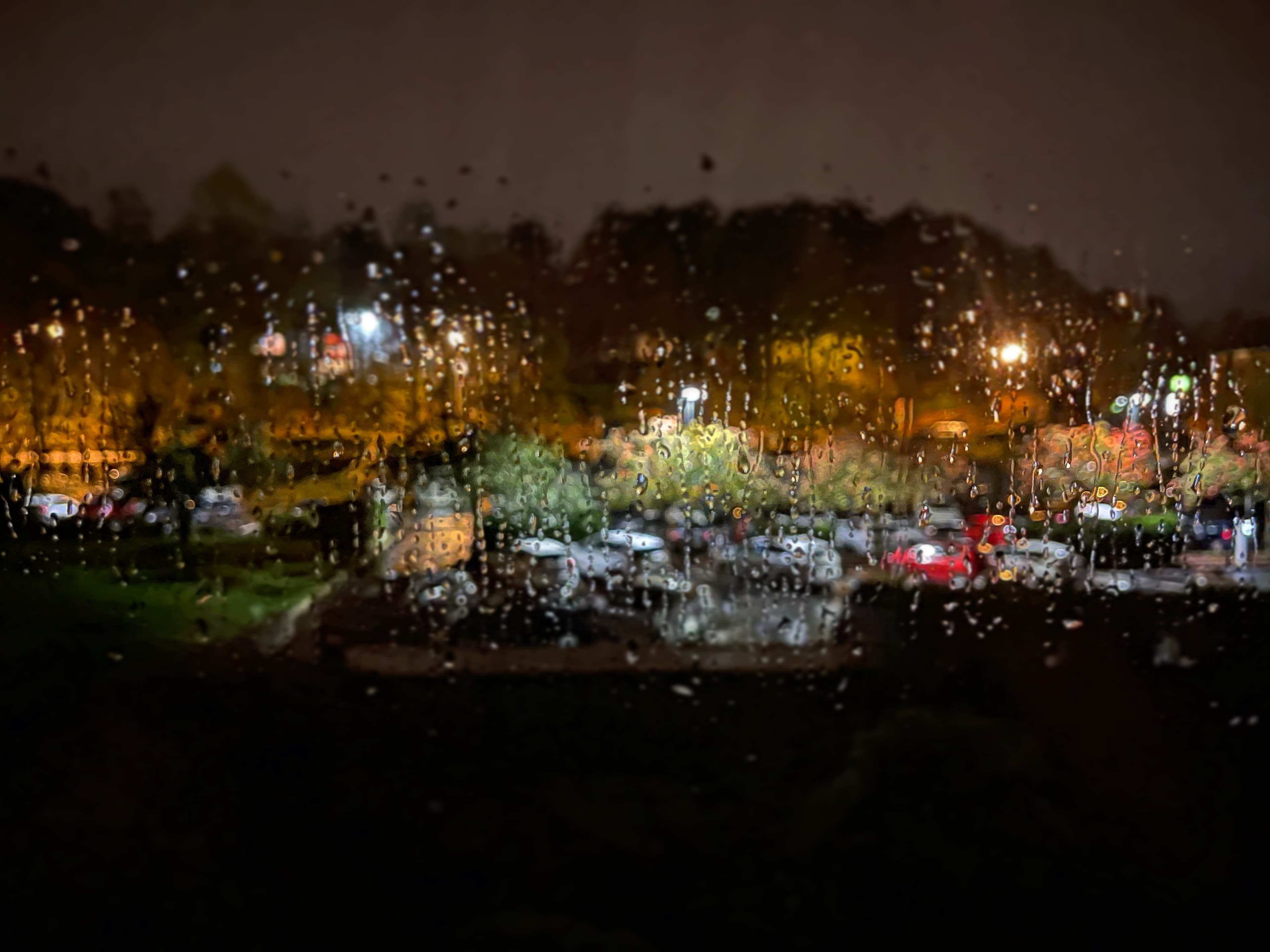 City lights glowing softly through a rain-covered window